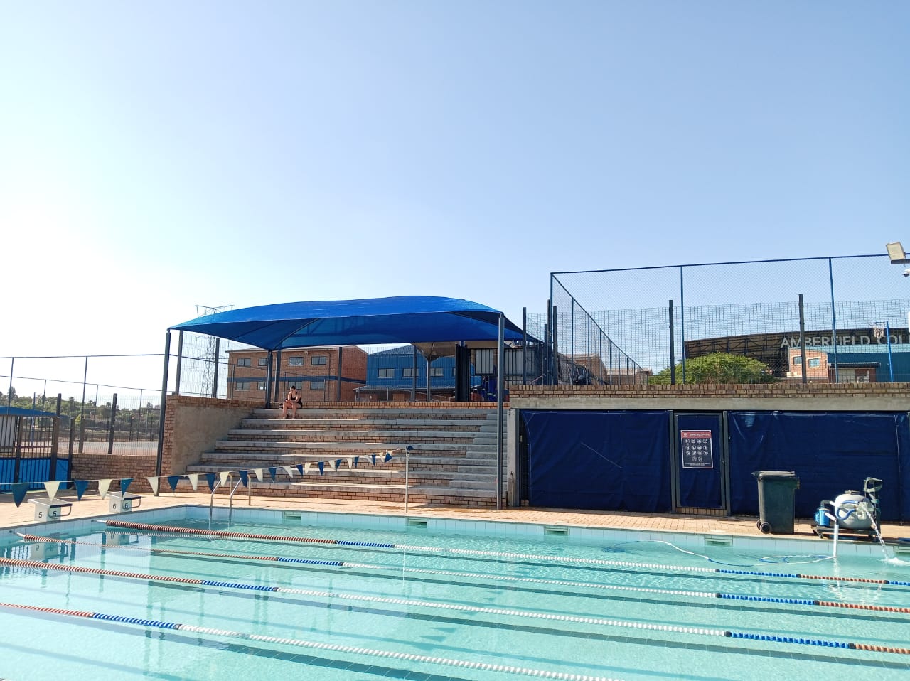 Blue poolside shade structure